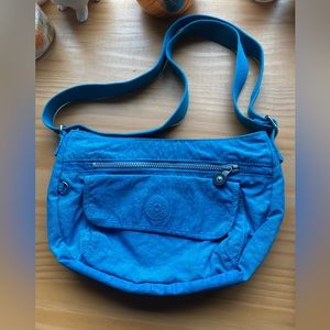 A Kipling bag with a vibrant, beautiful blue color! It has multiple compartments